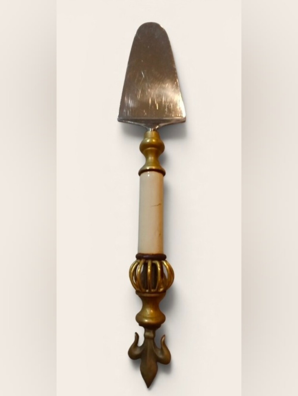Antique pie server with an ornate brass Fleur De Lis handle, 11"